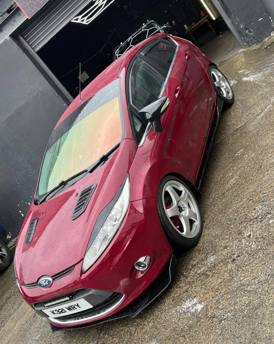Red Ford Fiesta outside the unit after a detail