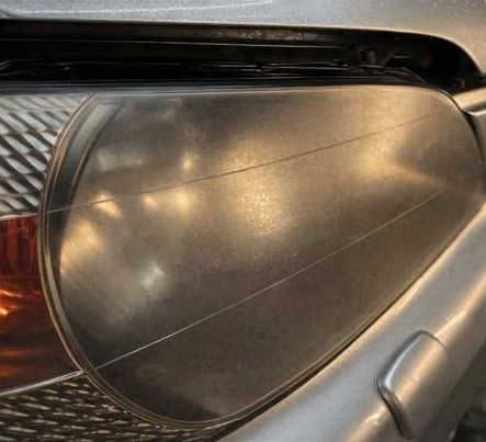Headlight lens hazed and yellowed before restoration