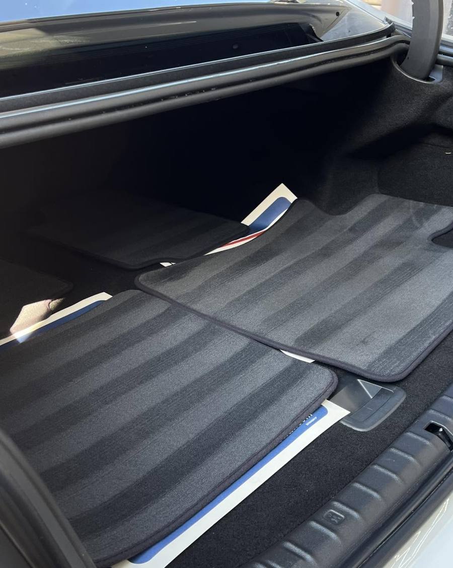 Boot carpet vacuumed with mats laid back in
